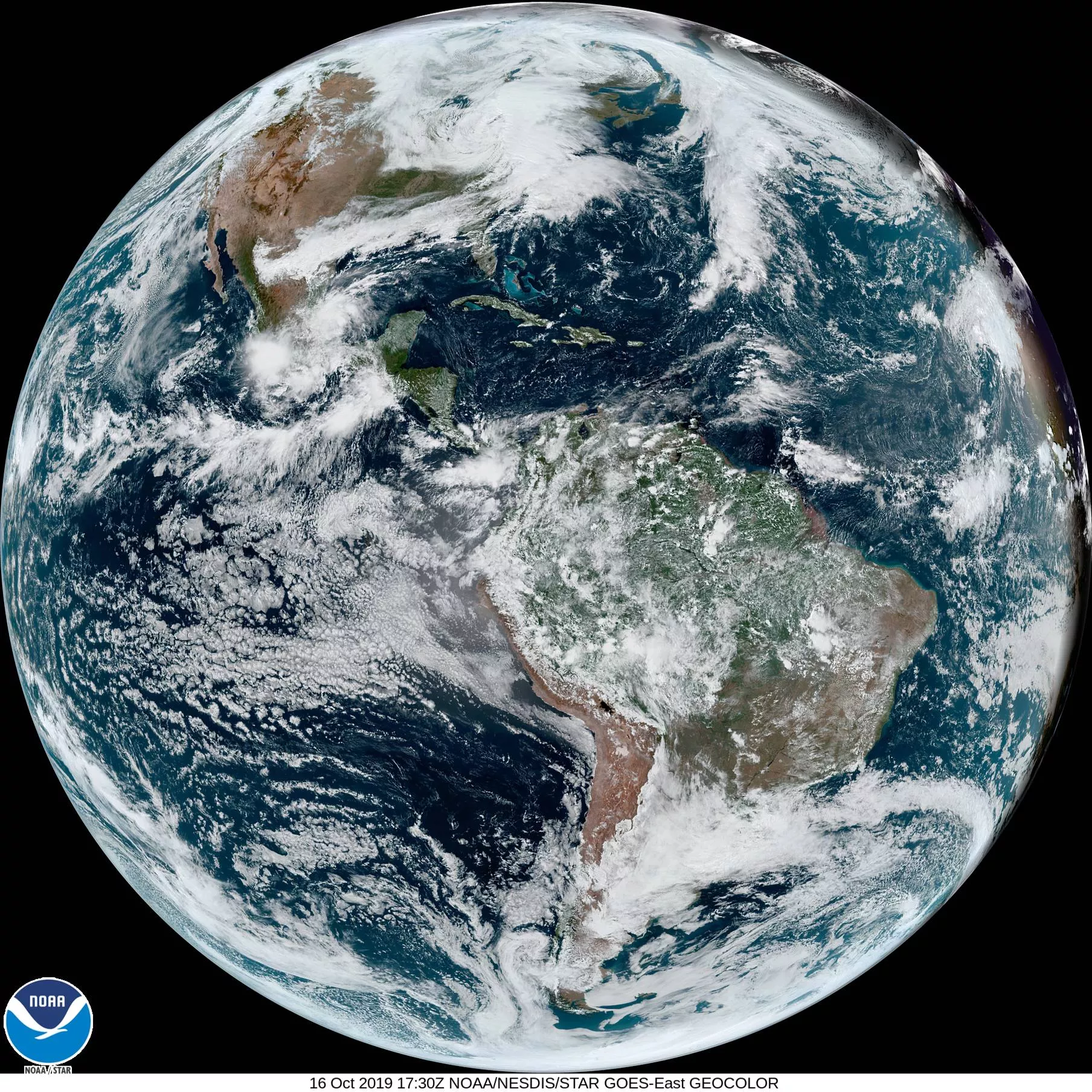 Full disk image of the Western Hemisphere, that approximates what the human eye would see from space. Land is brown/green; water is blue; clouds are white. 