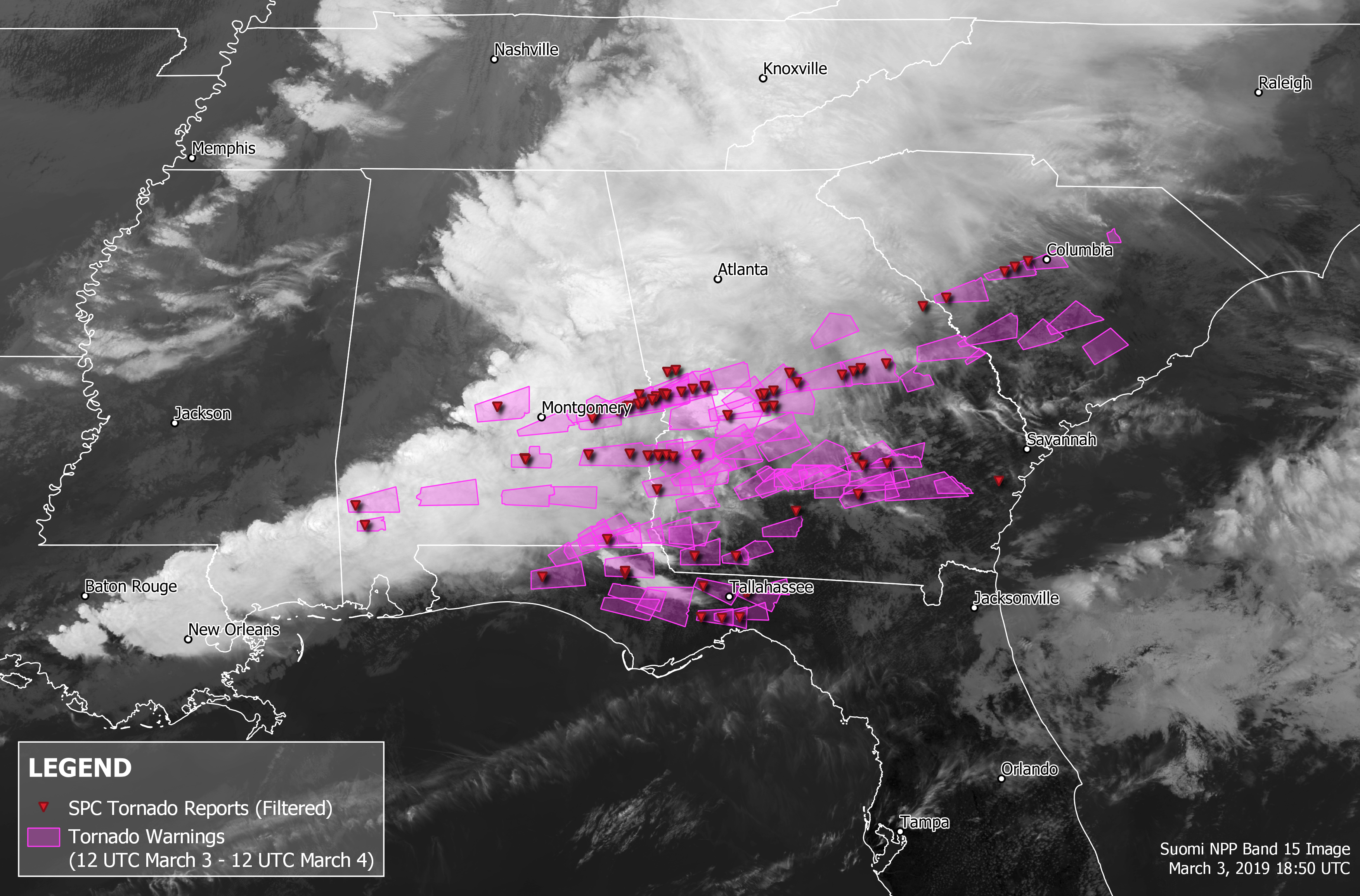 On a black-and-white satellite image of storms over Alabama, tornado warning areas are indicated in pink boxes and tornado reports received by the Storm Prediction Center are indicated with red dots.