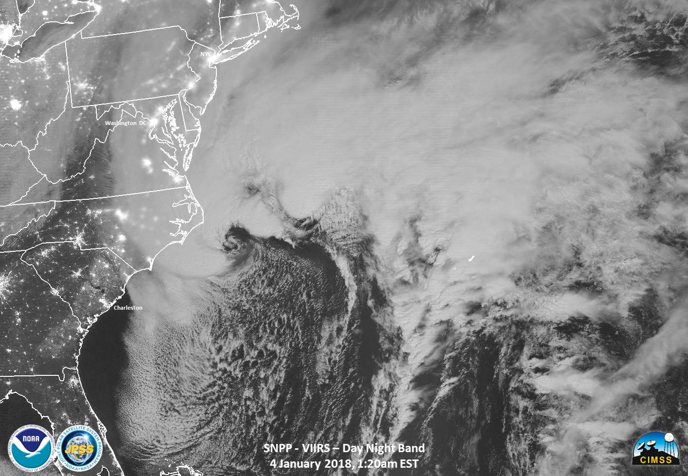 A black and white satellite image of the Mid-Atlantic coast of the U.S. shows a large mass of storm clouds stretching along the edge of the coast from South Carolina to Massachusetts and over the Atlantic Ocean.
