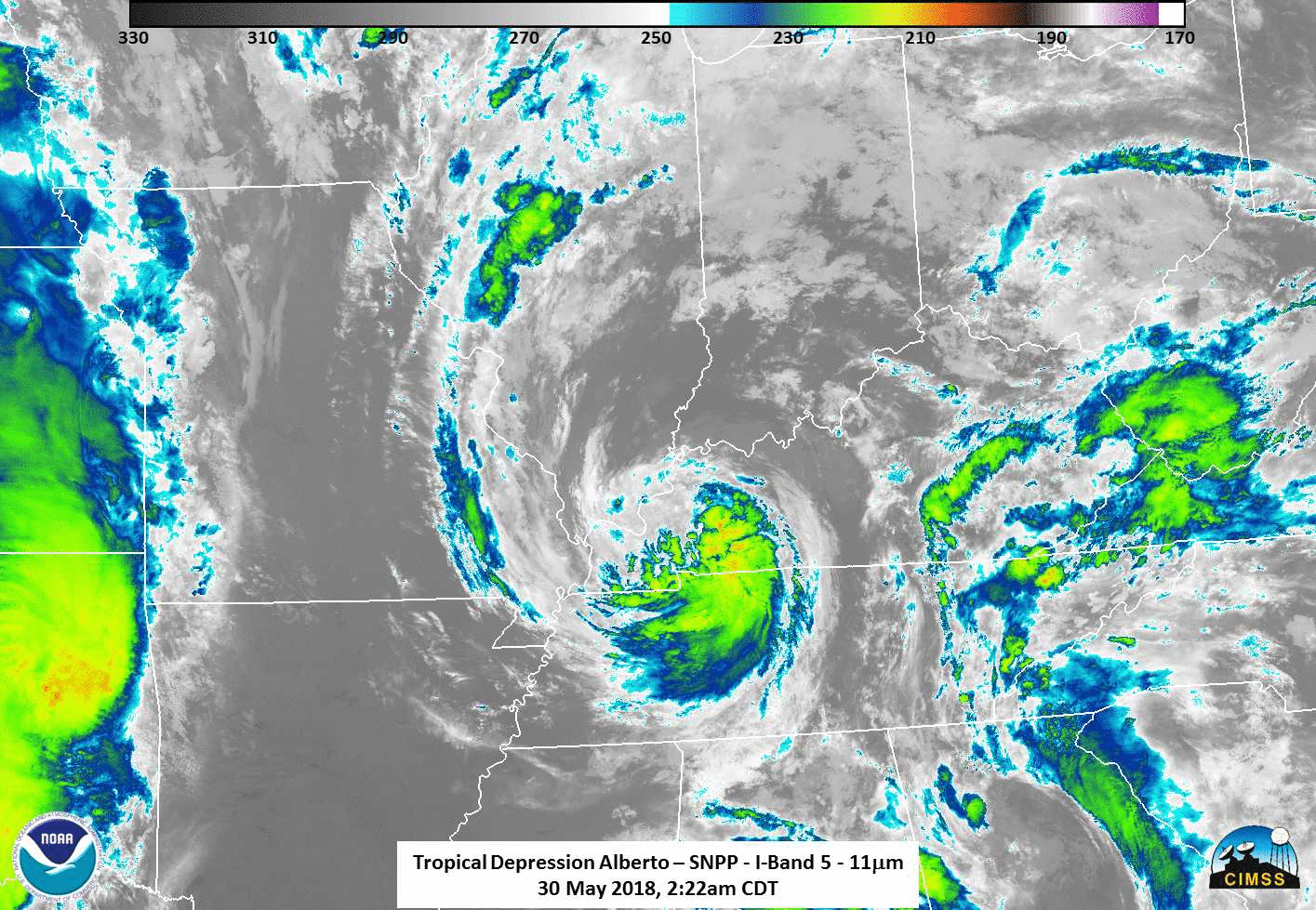 An animation flips between two infrared images of Tropical Depression Alberto over Tennessee and Kentucky. The majority of the image is in black and white, but the round-ish storm is in blue, green and yellow. The storm moves slightly northward in the second image.