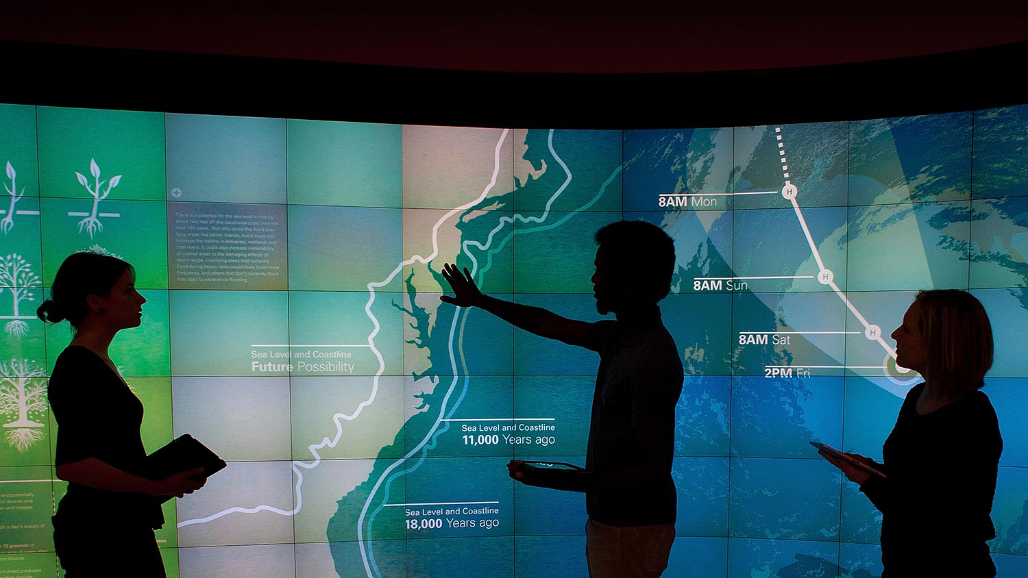 A composite image; at top, three different views of a large antenna on top of a building; on bottom, a man and a woman sit in front of  eight monitors showing different kinds of weather data.