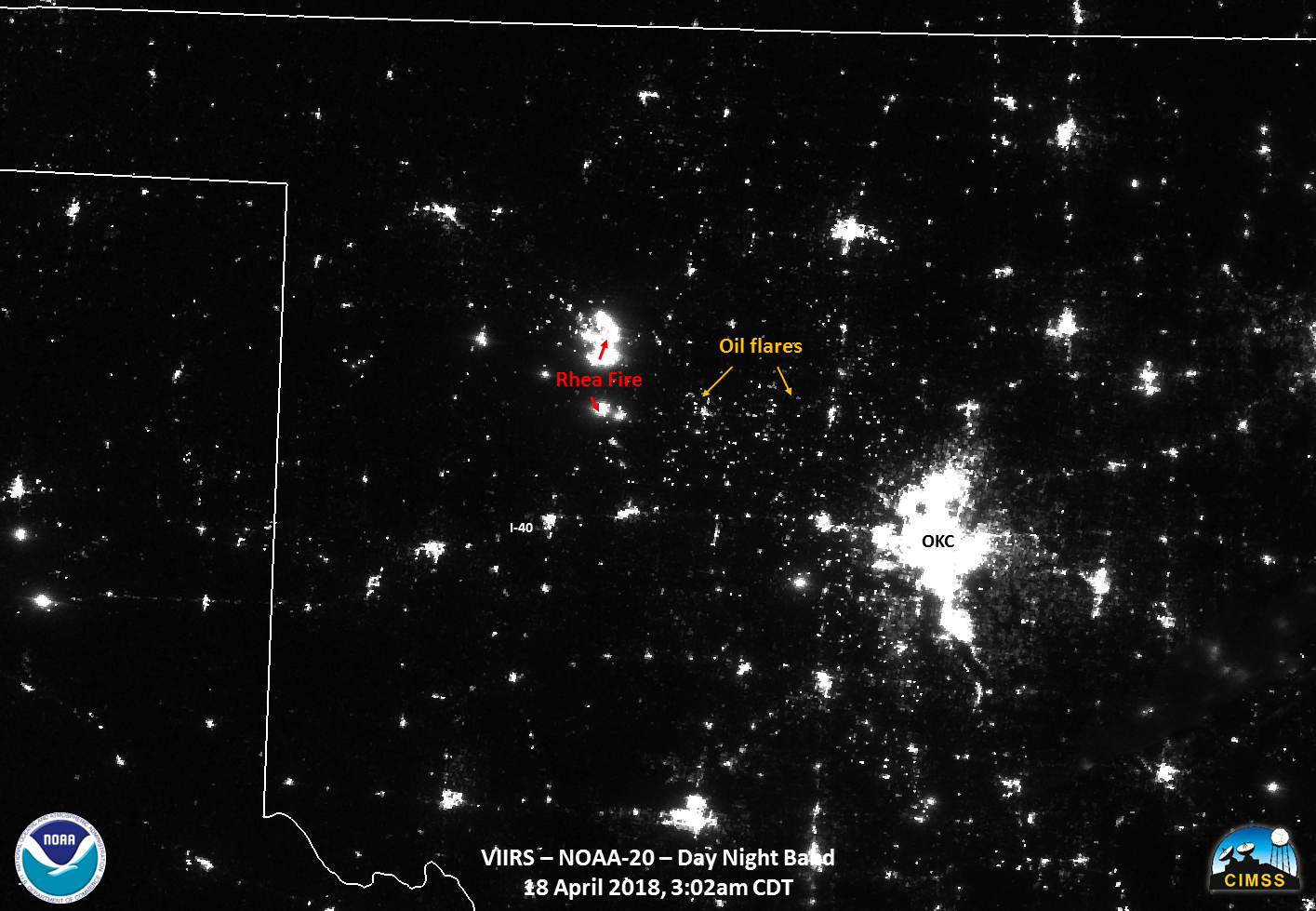 A black-and-white image of Oklahoma and the surrounding area indicates areas of brightness at night. A large white spot in the middle of the image indicates lights at night in Oklahoma City. Just west of there, a white spot almost as large indicates where the Rhea Fire is giving off light.