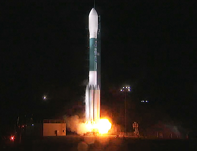 The rocket carrying JPSS-1 prepares to lift off from the pad during a nighttime launch.