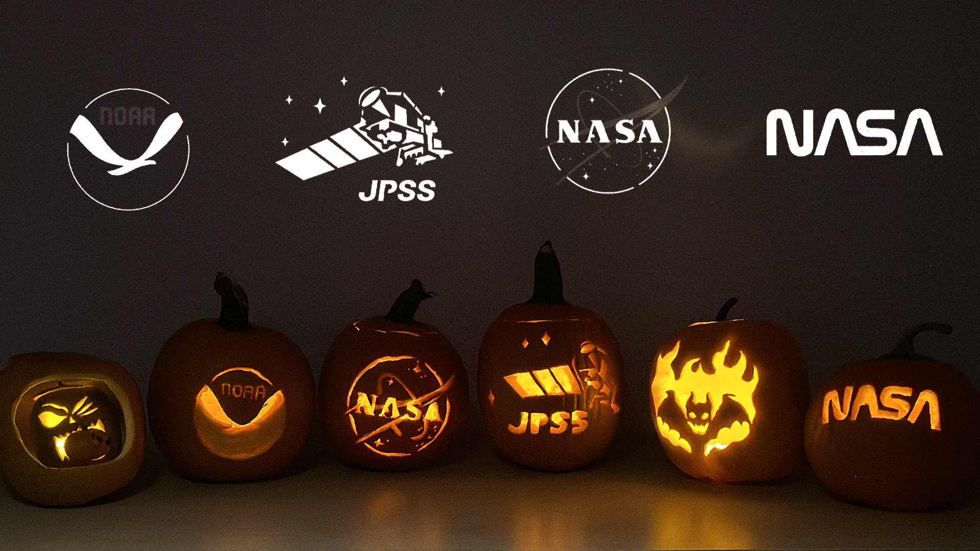 Carved pumpkins flickering in a dark room, with logos of NOAA, JPSS, and NASA above.