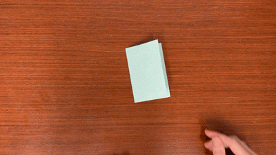 Animation of hands unfolding paper to reveal 8 sections.