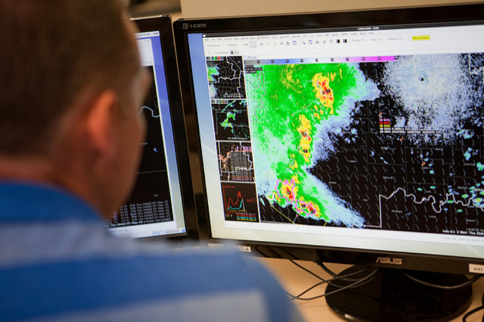 A meteorologist monitors severe weather data on dual screens showing storm intensity, movement, and analysis tools. Source: NOAA image. Source: https://www.ssec.wisc.edu/news/articles/8965 