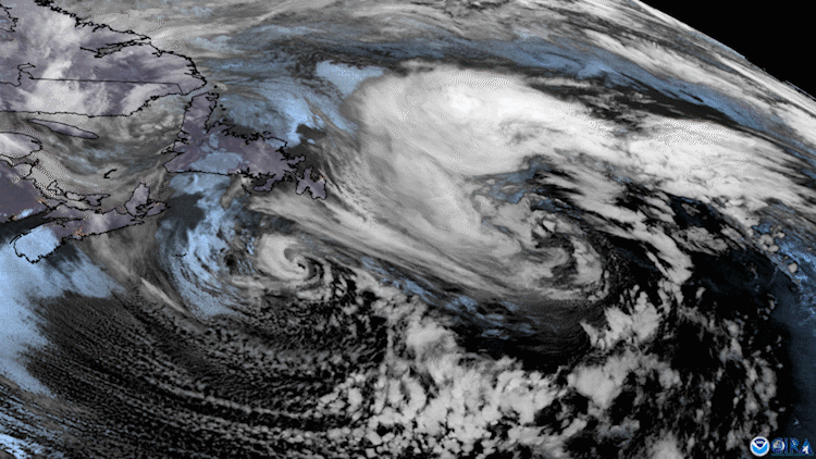 Animated loop showing low pressure systems swirling over the North Atlantic while cloud streets stream off the coast.