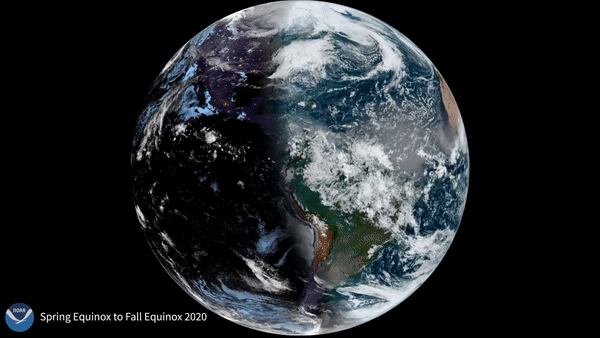 View of Earth from space focusing on the Western Hemisphere - white clouds float over brown/green land and blue oceans and brown Saharan dust is seen blowing off the coast of Africa into the Atlantic Ocean.  Half of the scene is sunlit and the other in dark shadow - showing when the amount of daylight and darkness is “nearly” equal at all latitudes. 
