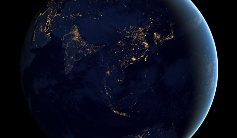 Satellite image of city lights onto globe projection of Earth, with a view of Asia