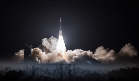 Image of JPSS-1 Satellite taking off from the launch pad on a rocket at night.