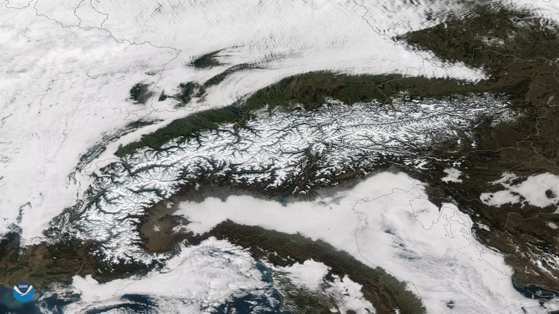 Clear skies reveal the snow-covered European Alps