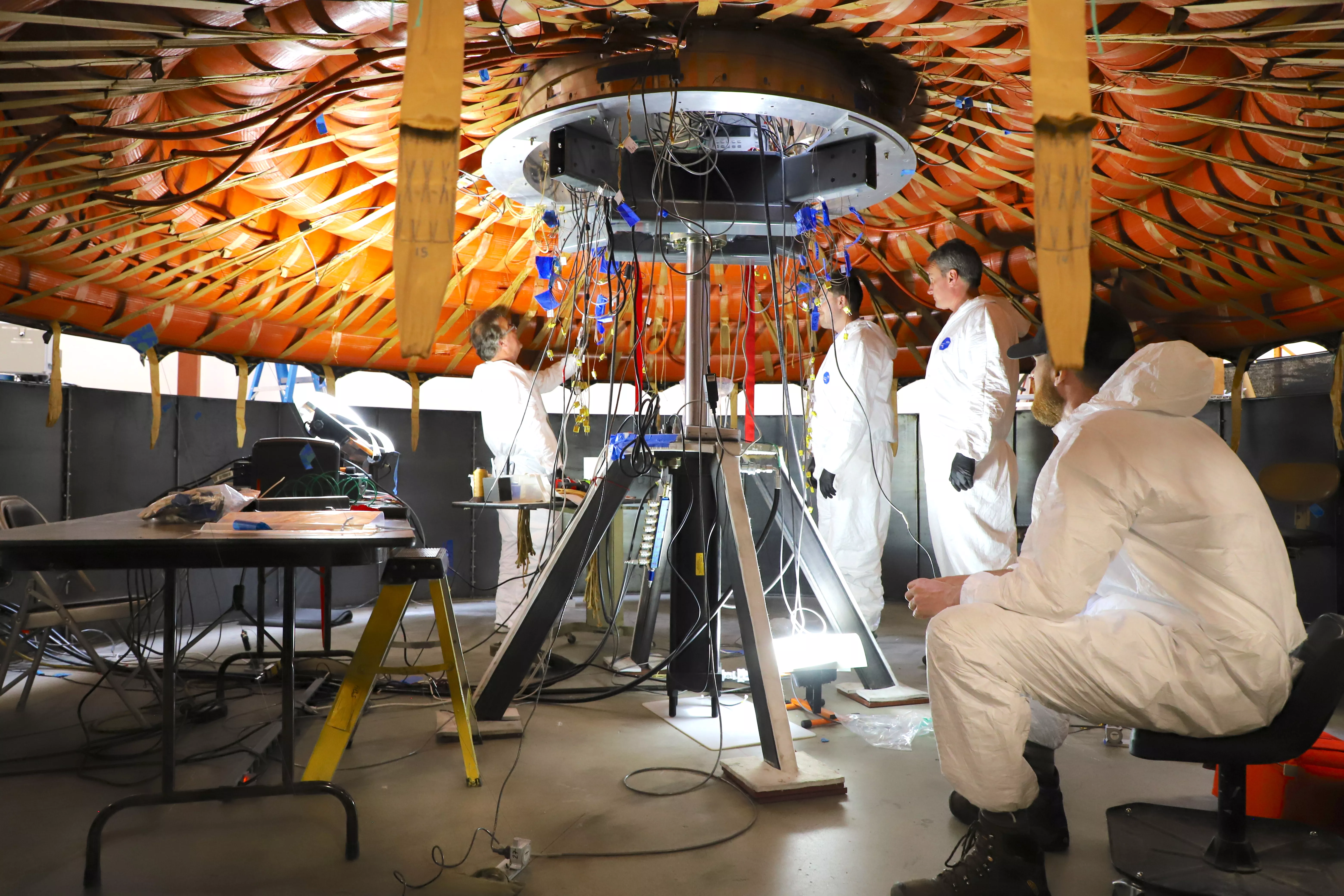 Photo of NASA engineers testing equipment in lab.