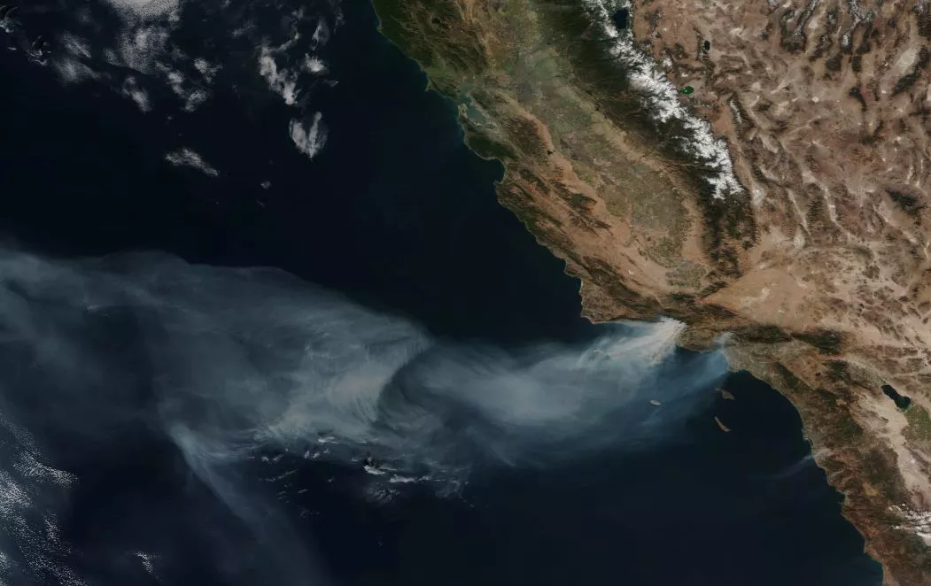 his December 6, 2017, true-color image from Suomi NPP’s VIIRS instrument shows large plume of smoke drifting out over the Pacific, pushed by the strong Santa Ana winds.