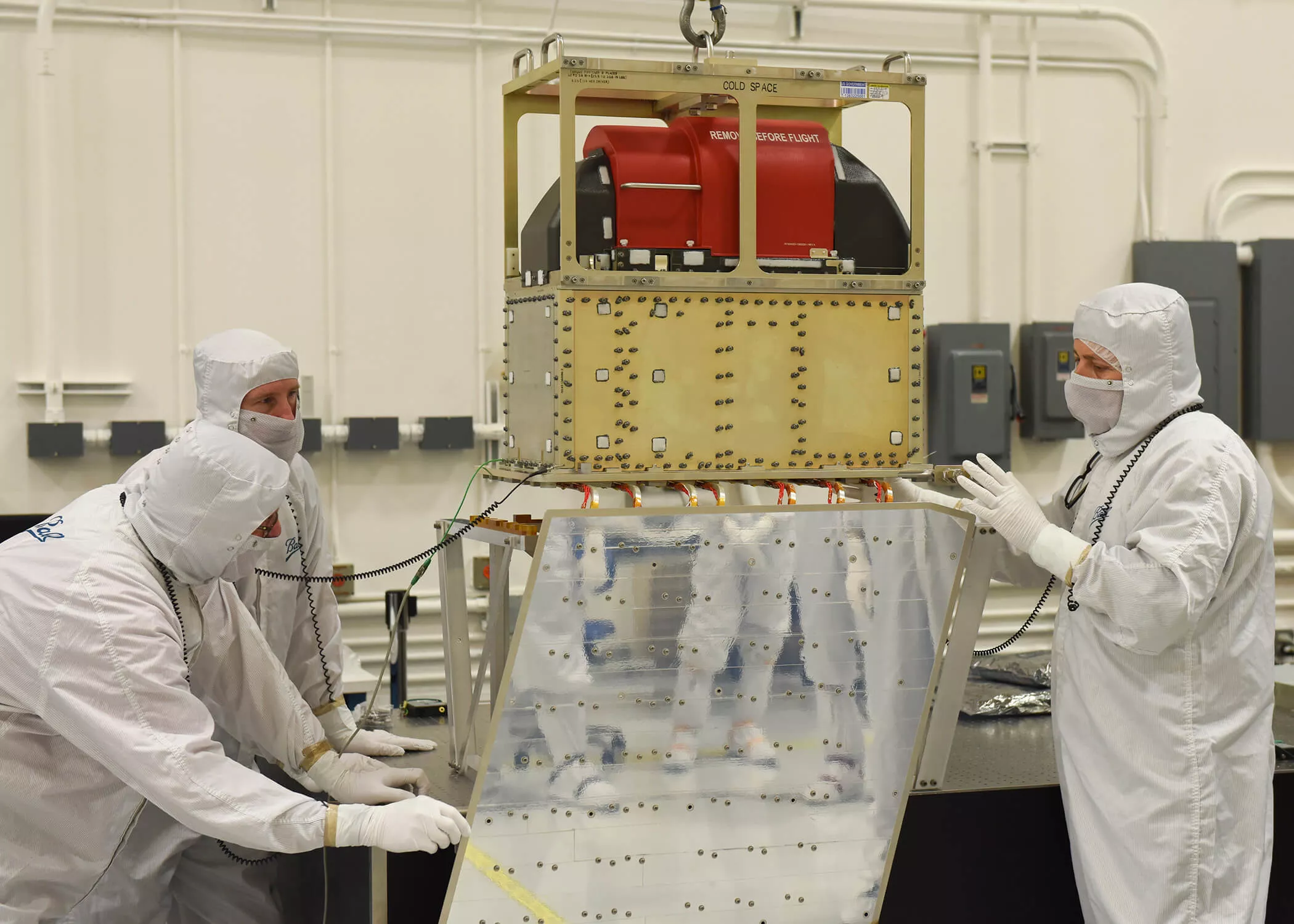 Ball Aerospace technicians lower the ATMS instrument onto the JPSS-1 spacecraft. Credit: Ball Aerospace & Technologies Corp
