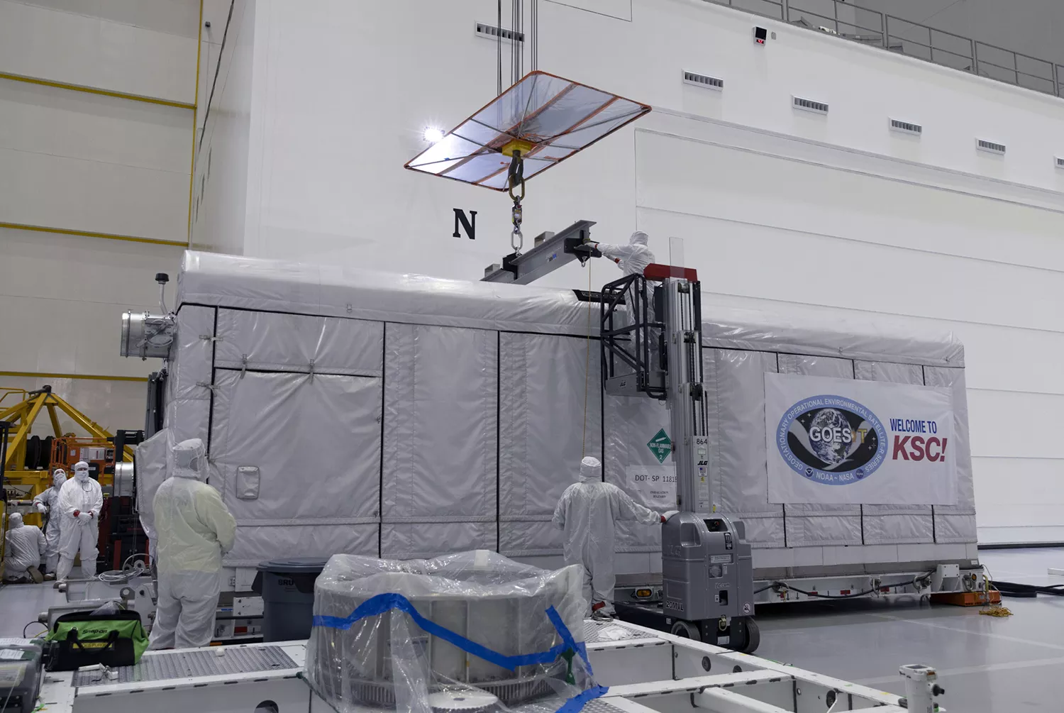 Crews carefully bring GOES-T is into Astrotech's payload processing facility