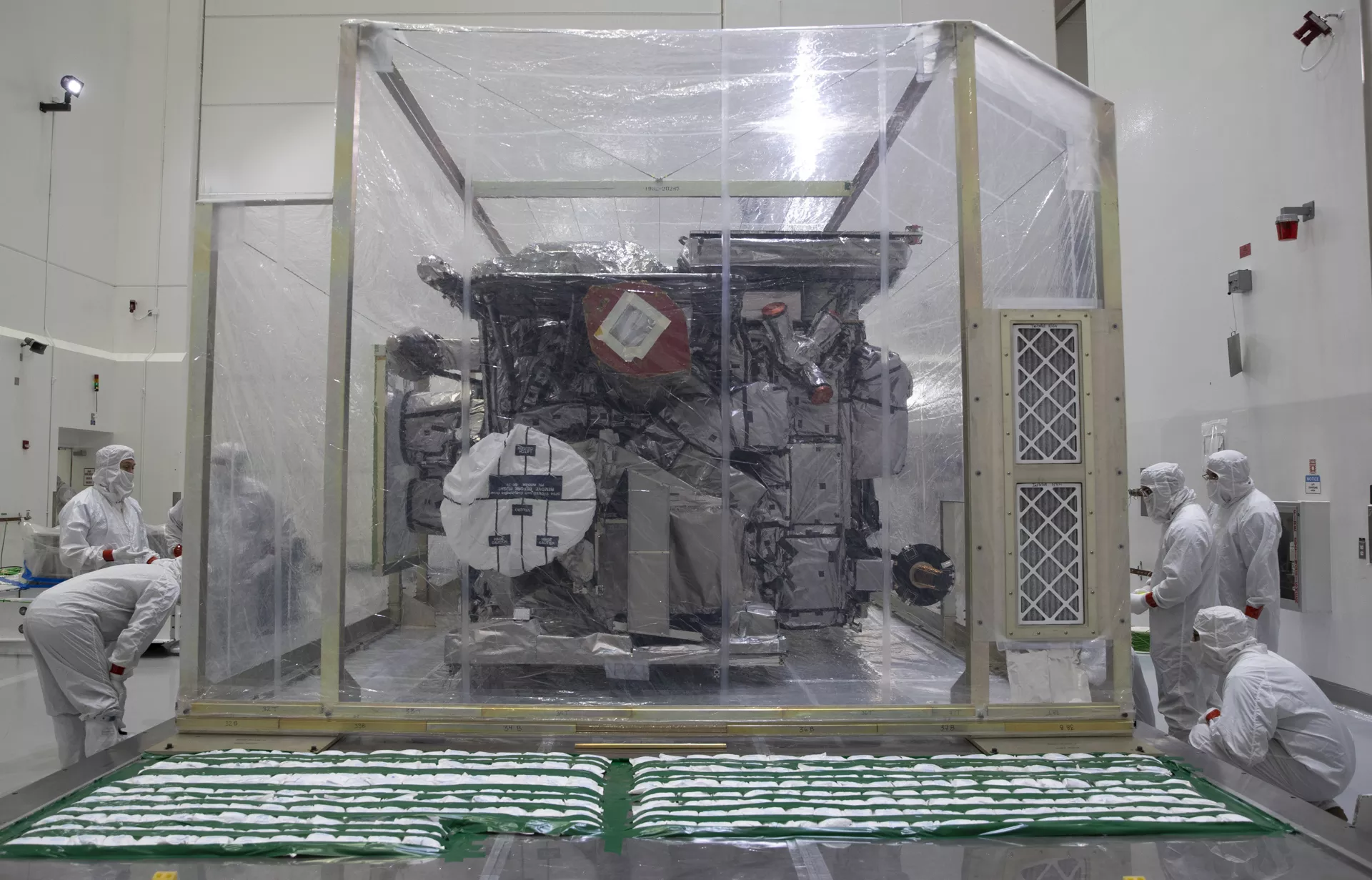 Staff inspects GOES-T after it's shipping container has been opened.