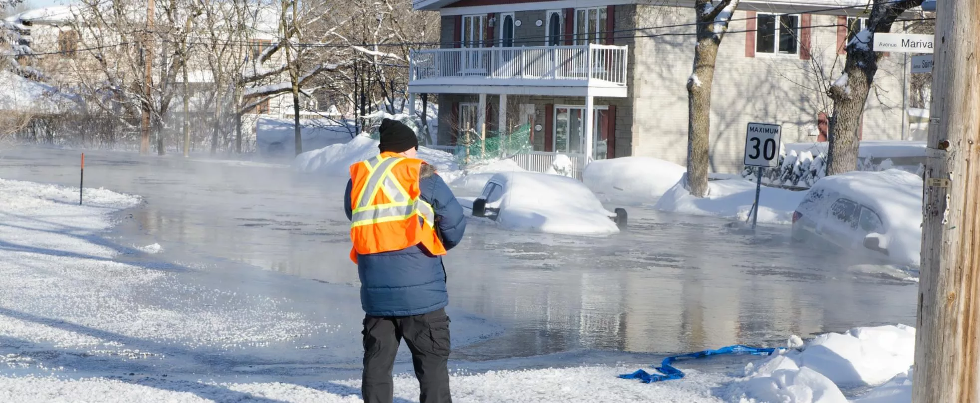 Image of cars in a flooded street that has been frozen over.