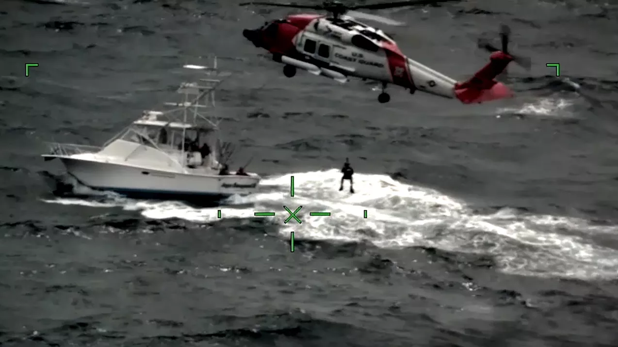 This image taken from a video shows a U.S. Coast Guard crew lifting a man to safety off Cape May, New Jersey. This SARSAT rescue was one of the 330 lives saved in 2021 aided by NOAA satellites. (USCG)