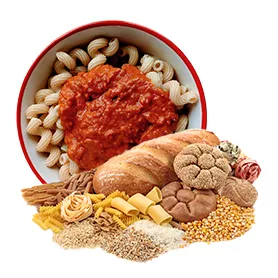 Bread, pasta and other wheat products in front of bowl with pasta and red sauce