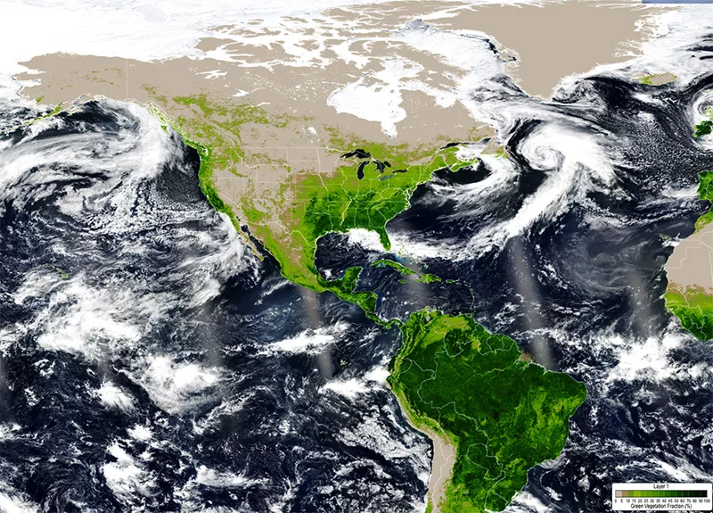 A satellite image of the Earth with enhanced color areas representing the greenery of plants.