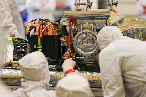 Image of engineers working on the CCOR instrument for the Space Weather Follow On program.