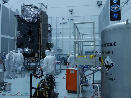 image of personnel fueling a satellite in a lab.