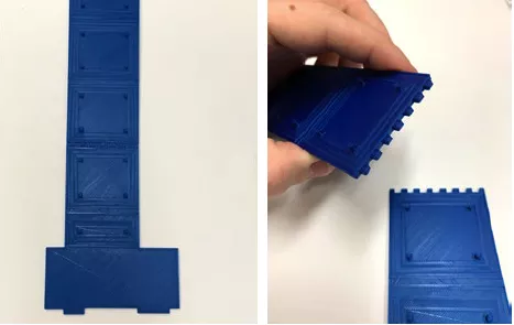Close-up photo of the 3D printed solar panel. Close-up photo of a hand holding a 3D printed "piece" with teeth about to attach to another piece with teeth.