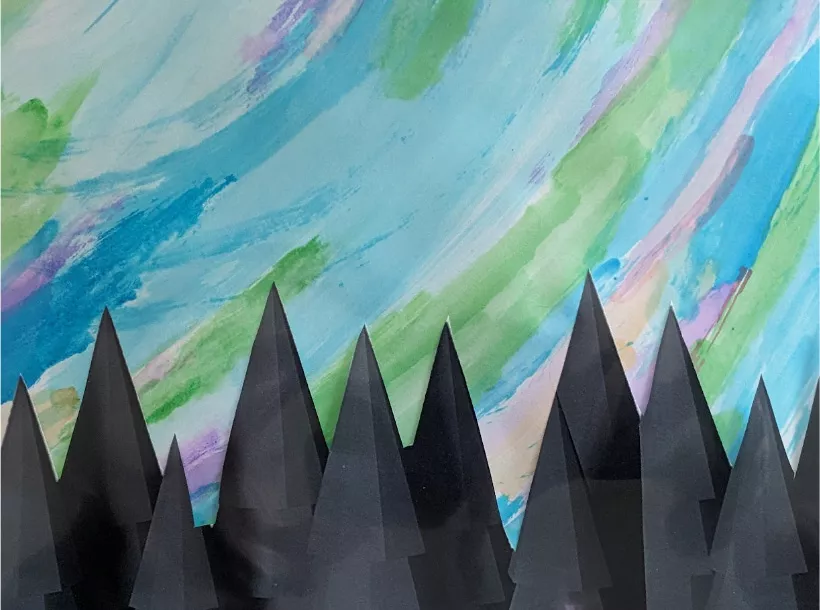 Image of colorful watercolor paint strokes on paper and black paper cut-outs resembling a coniferous tree tops.