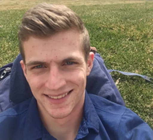 Lyle Prince smiling while outside on a lawn.