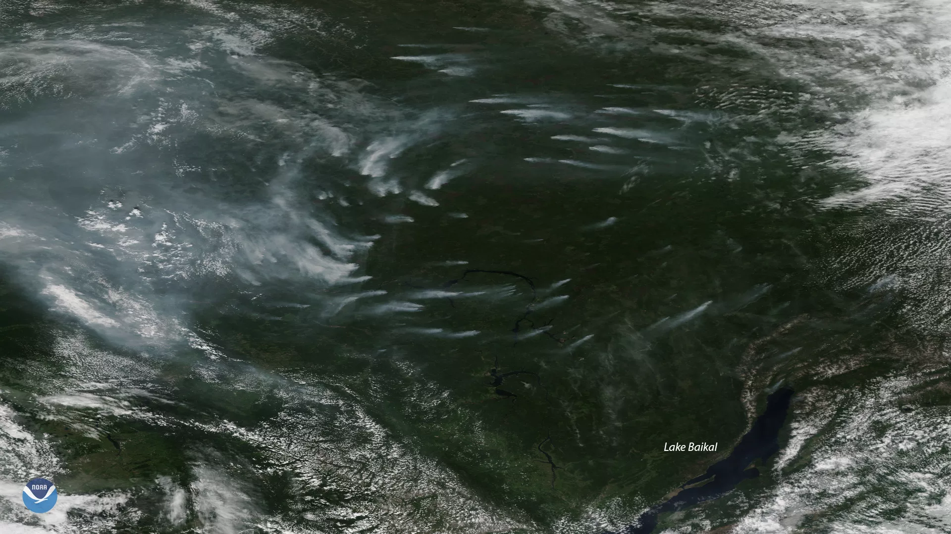 Plumes of smoke from active wildfires burning near Lake Baikal in Russia, seen via NOAA-20's True Color imagery from July 4, 2019.
