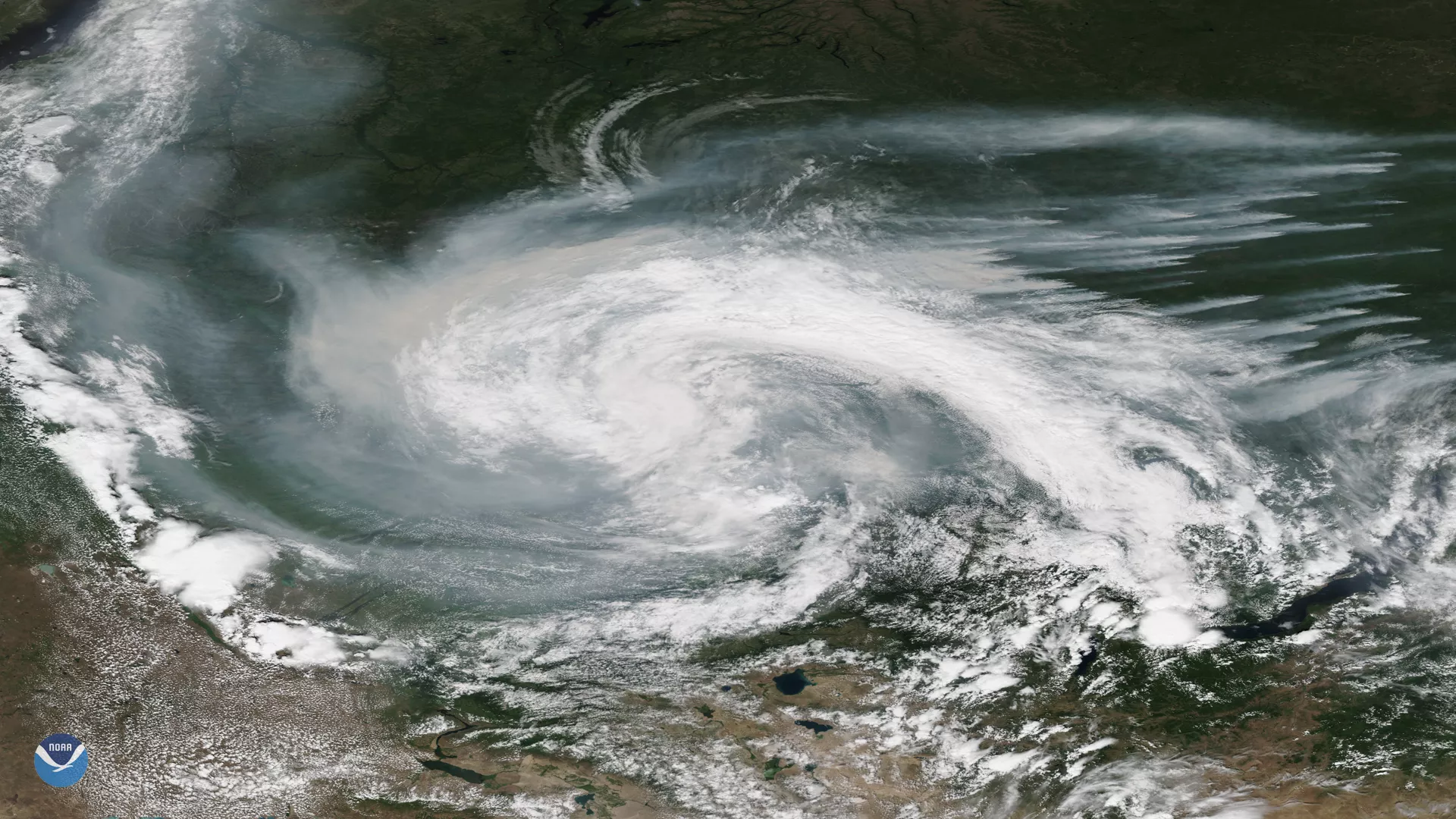 Smoke from active wildfires burning across northern Russia got caught in a low pressure system near the Verkhne-Tazovsky State Natural Reserve on July 21, 2019, as seen here by this True Color NOAA-20 satellite imagery.