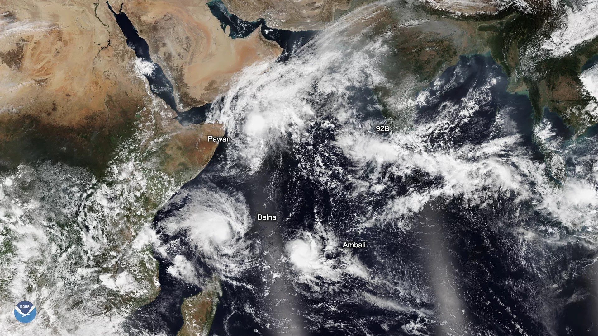  NOAA-20 satellite imagery of three tropical cyclones (Ambari, Belna, and Pawan) over the Indian Ocean, along with remnants of a fourth off the coast of Gujarat in western India and a developing system, 92B, off the southern tip of India.