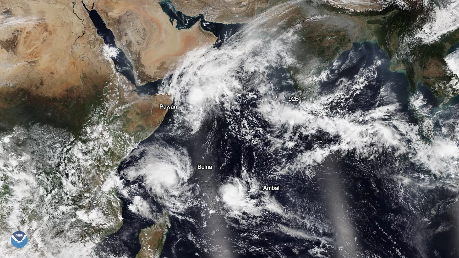 NOAA-20 satellite imagery of three tropical cyclones (Ambari, Belna, and Pawan) over the Indian Ocean, along with remnants of a fourth off the coast of Gujarat in western India and a developing system, 92B, off the southern tip of India.