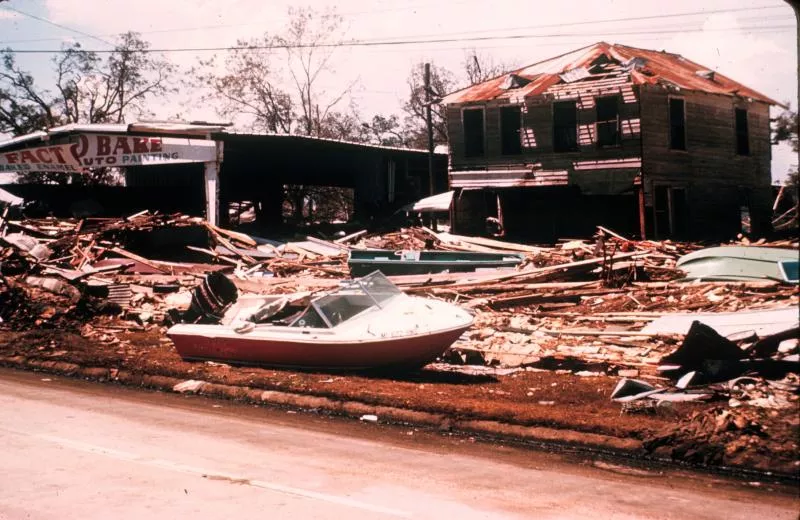 Photo of Camille's damage on the Gulf coast, showing destroyed houses and a boat run aground.