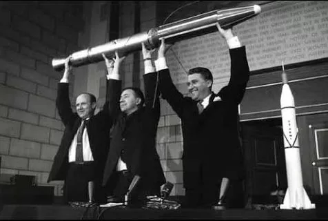 Photo of men holding a rocket