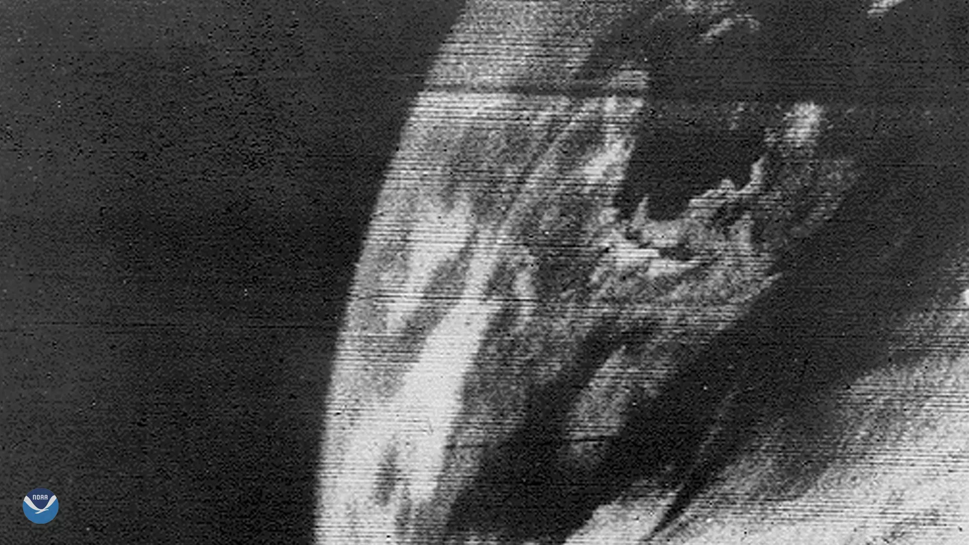 Blurry black and white image showing part of North America from space.