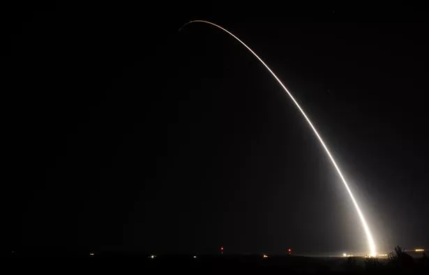 Photo of satellite launch at Vandenburg AFB, taken at night.