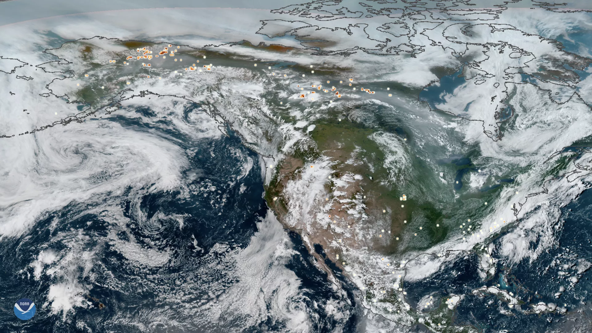 Merged GOES East and West true-color imagery of smoke from Arctic wildfires spreading across Alaska and Canada, with overlay showing heat signatures of fires from VIIRS, on July 23, 2019.