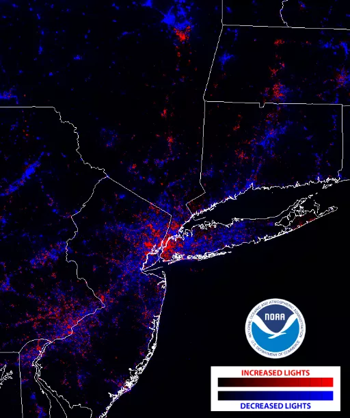 An image showing more of the surrrounding area of New York City; dimmed lights are indicated in blue and increased lights are indicated in red. There is quite a bit of blue around New York City, and red stretching into upstate New York, New Jersey, Long Island, Connecticut and Massachusetts.