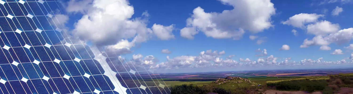 Image of solar panels and cloudy sky.